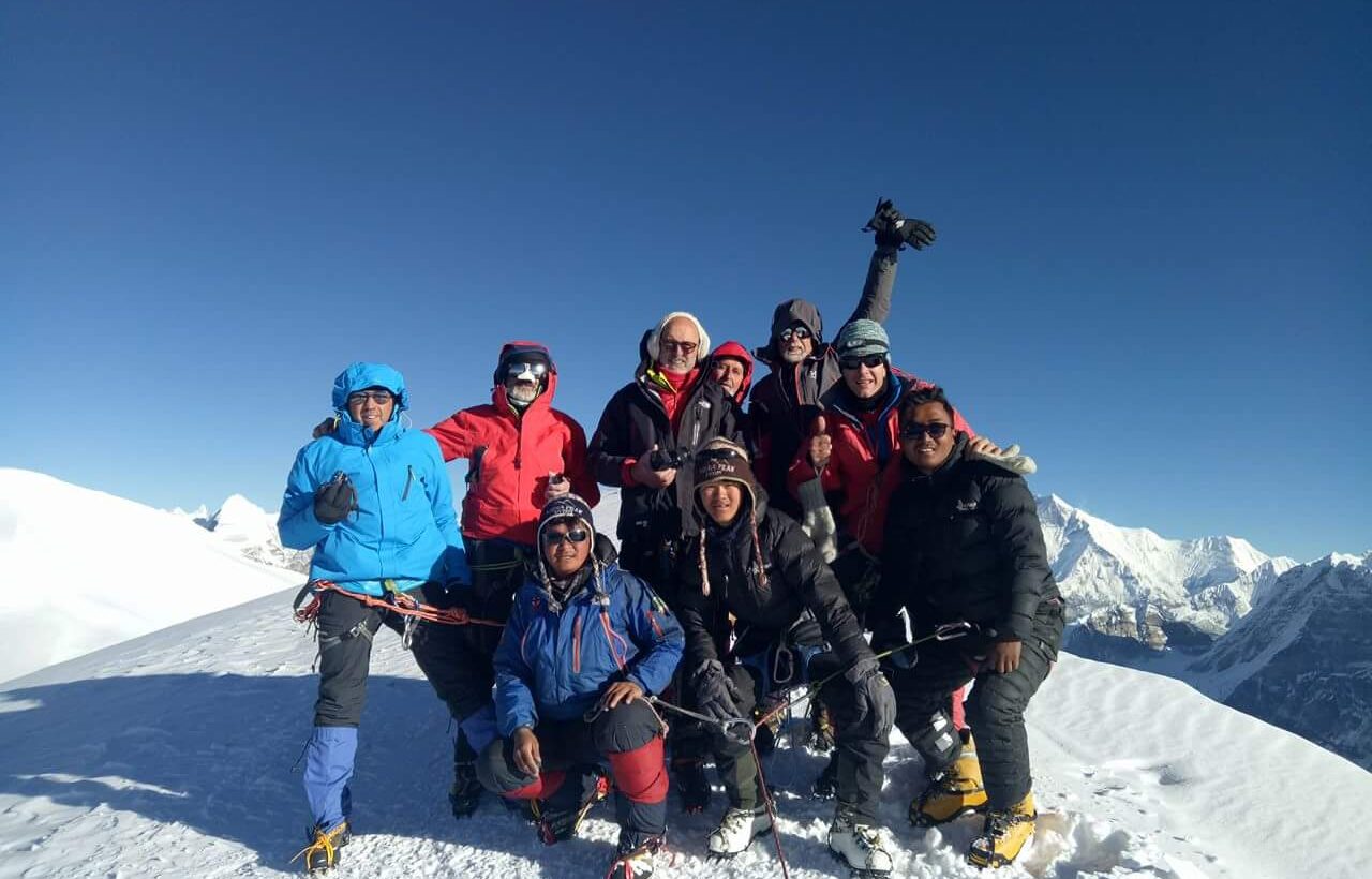 Group of climbers celebrating at the summit during Mera Peak climbing in Nepal,