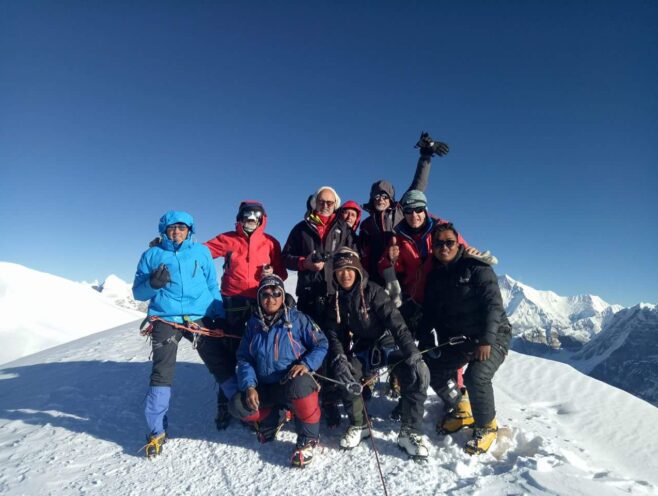 Group of climbers celebrating at the summit during Mera Peak climbing in Nepal,