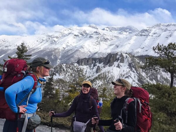 Trekkers on the Annapurna Circuit Trek admiring breathtaking views of the Annapurna mountain range.