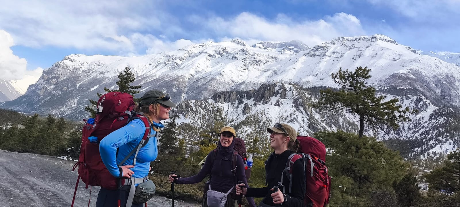 Trekkers on the Annapurna Circuit Trek admiring breathtaking views of the Annapurna mountain range.