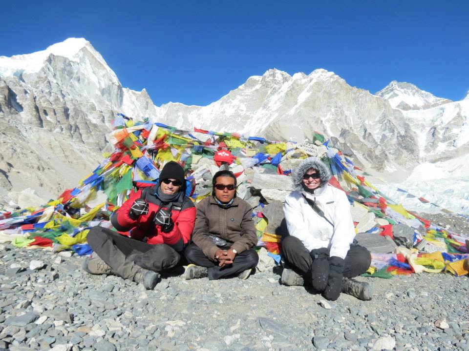 Three trekkers posing at Everest Base Camp