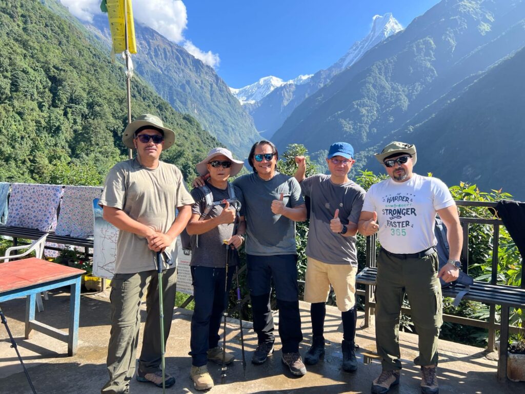 Happy trekkers enjoying the majestic Himalayan views on the ABC trek.