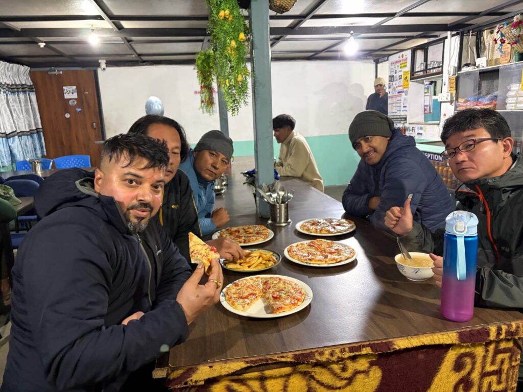 Enjoying delicious pizza and food with friends in Chhomrong Village,