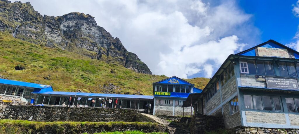 Machhapuchhre Base Camp (MBC) with mountain views and trekking lodges in the Annapurna region of Nepal.