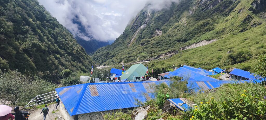Green hills and blue-roofed lodges along the ABC Trek.