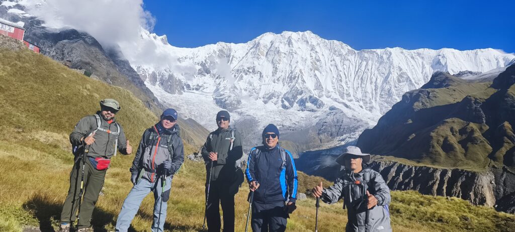 Group of trekkers facing the Annapurna Himalayan range in Nepal.