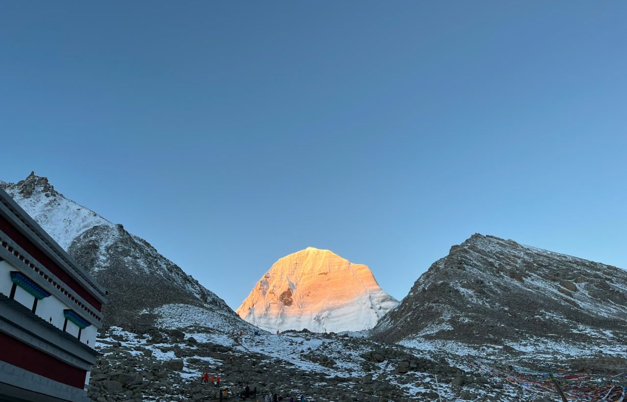 Colorful prayer flags covering the rocky terrain near Mount Kailash.